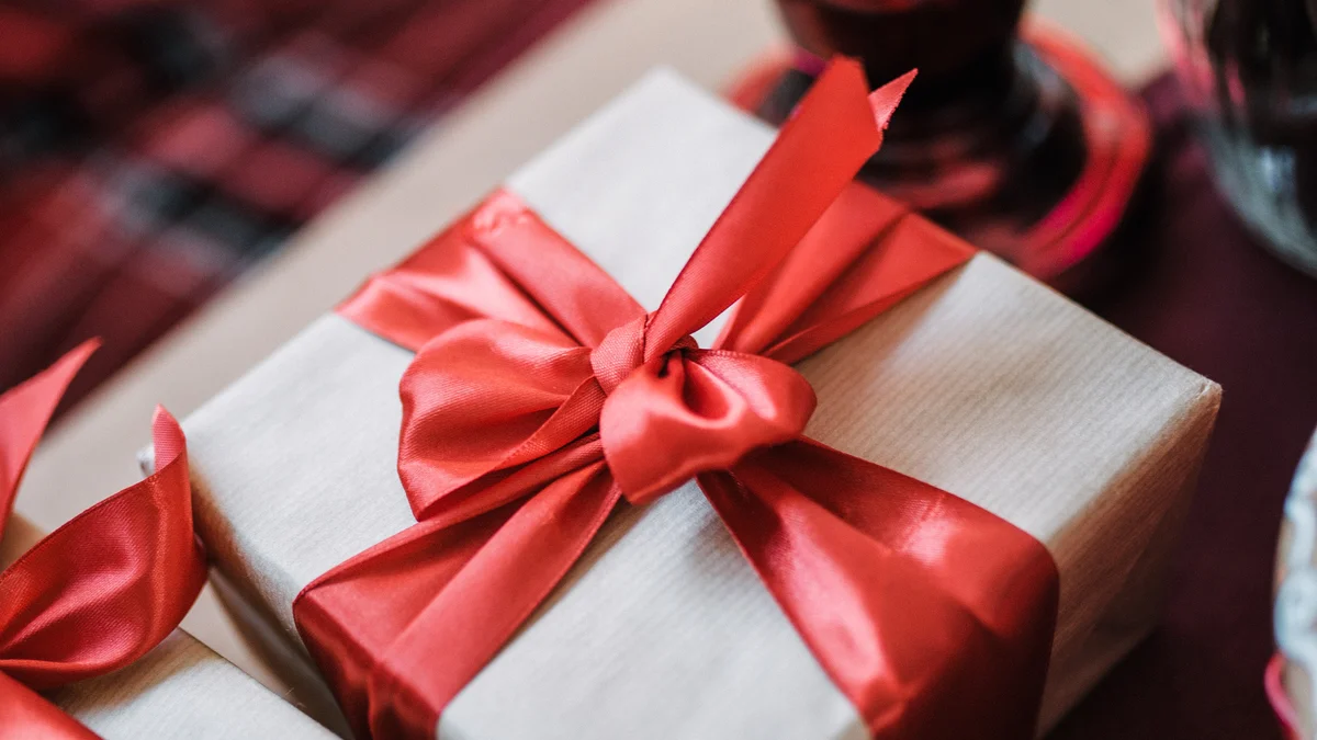 gifts for coworkers wrapped gift box with ribbon on office desk